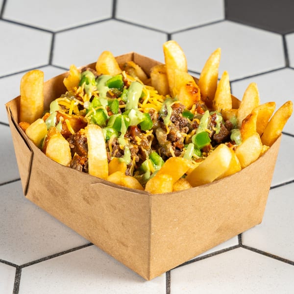 Golden fries loaded with seasoned meat, shredded cheese, green peppers, and creamy green sauce.